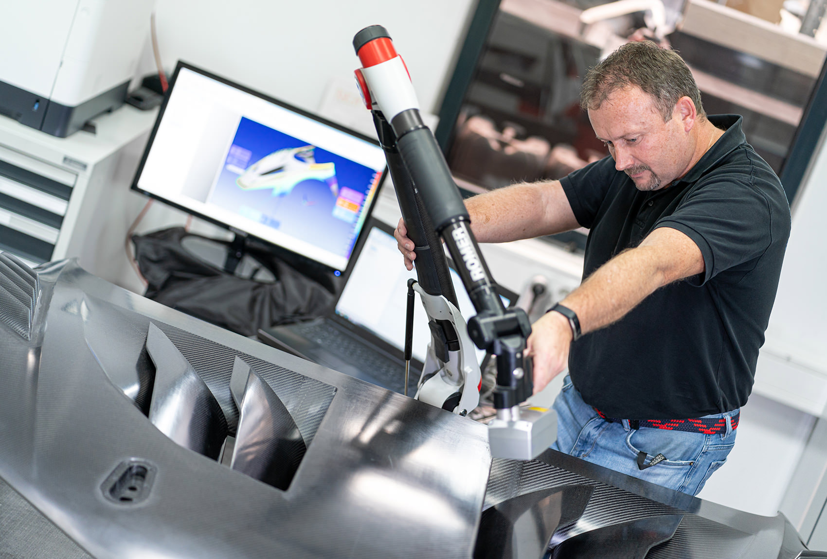 Mitarbeiter von Becker Carbon prüft Werkstückoberfläche mit einem mobilen Messarm von ROMER 